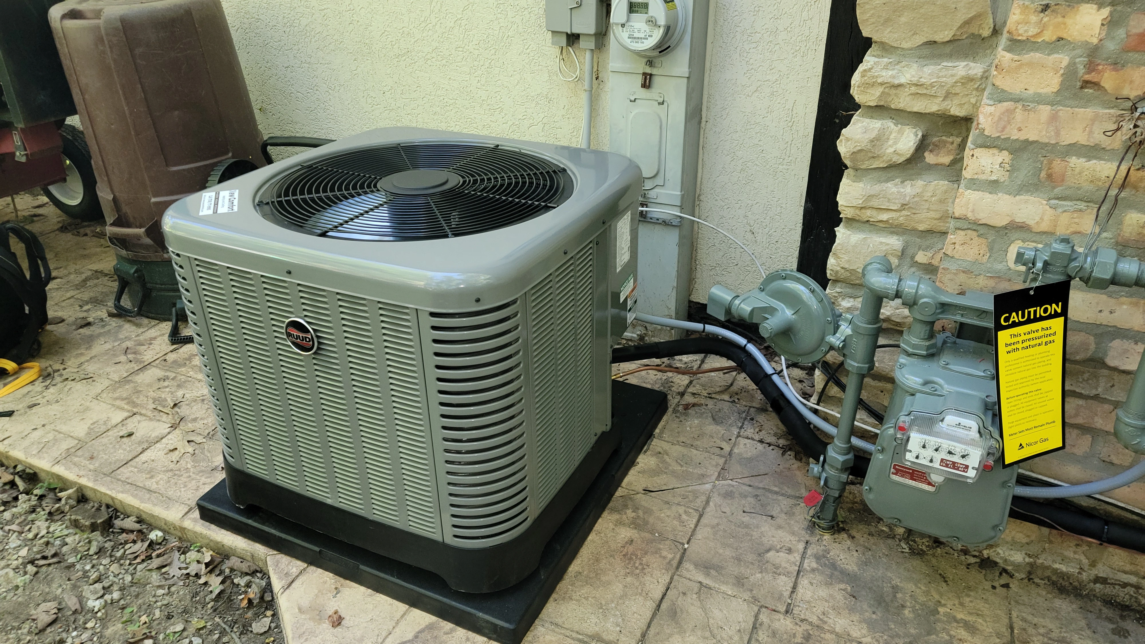 Clean outdoor AC condenser in a garden during a central air conditioning inspection