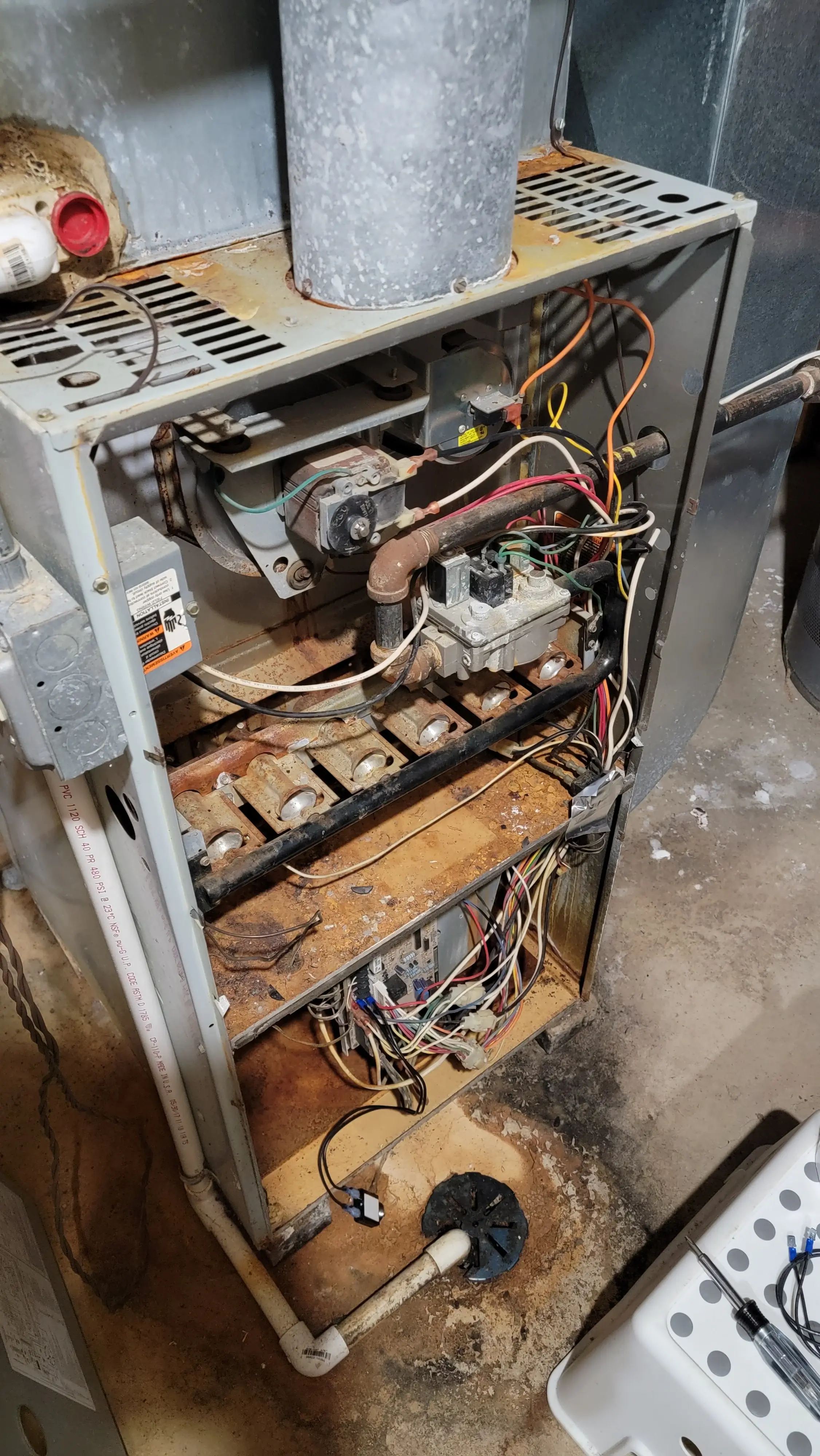Old corroded furnace with damaged wiring – weighing furnace repair vs replacement