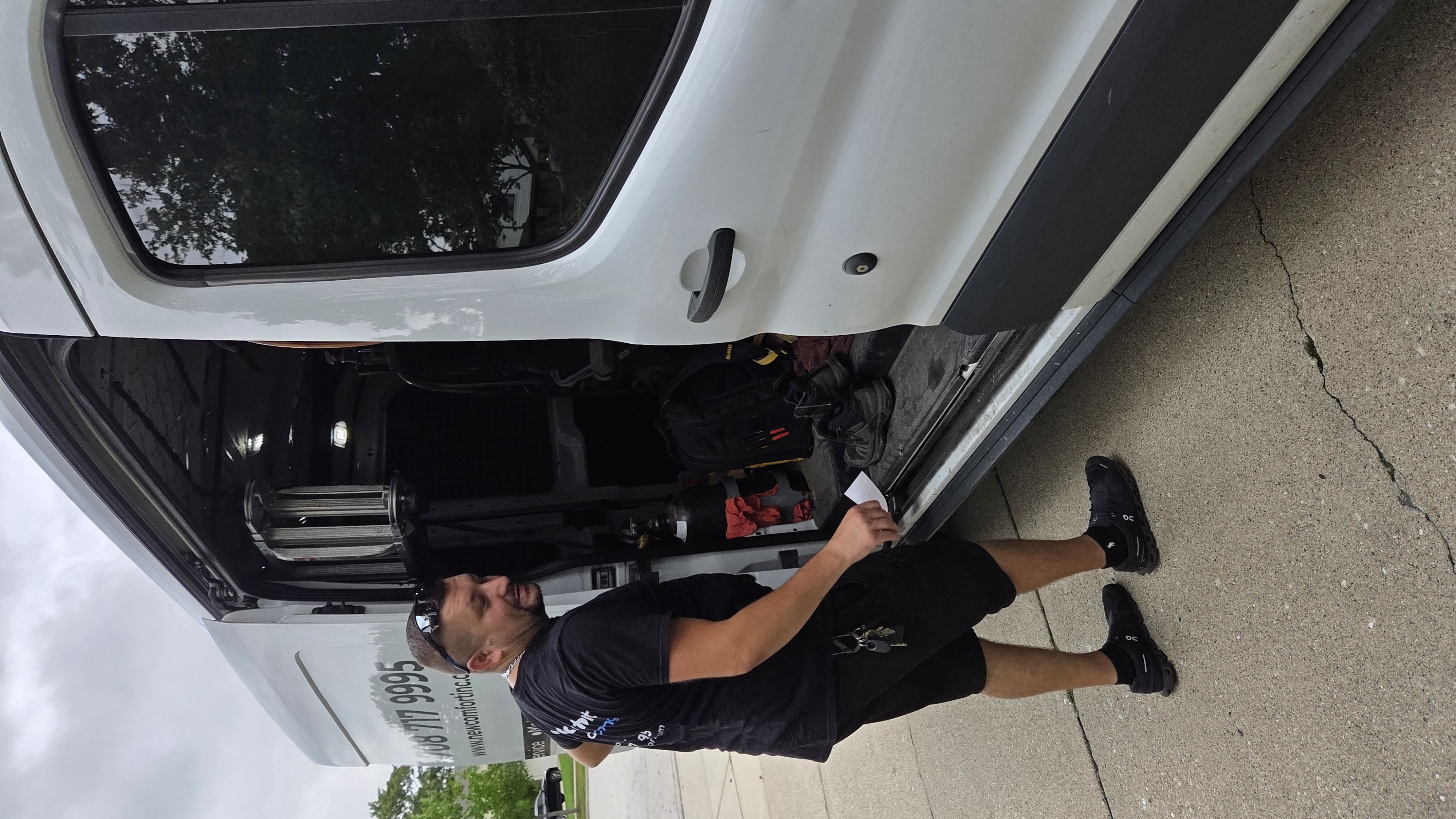 New Comfort technician loading tools from the service van - HVAC services Willow Springs IL