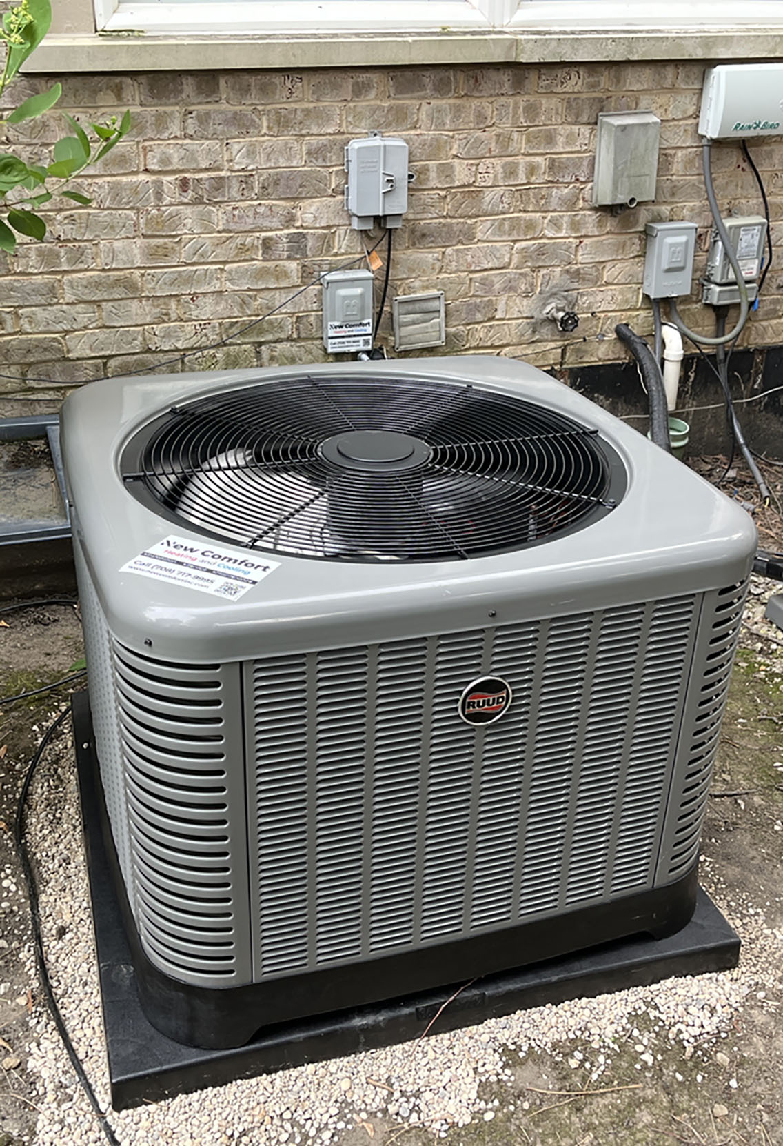 New central air conditioner condenser on a pad beside a brick home after an AC replacement in La Grange IL