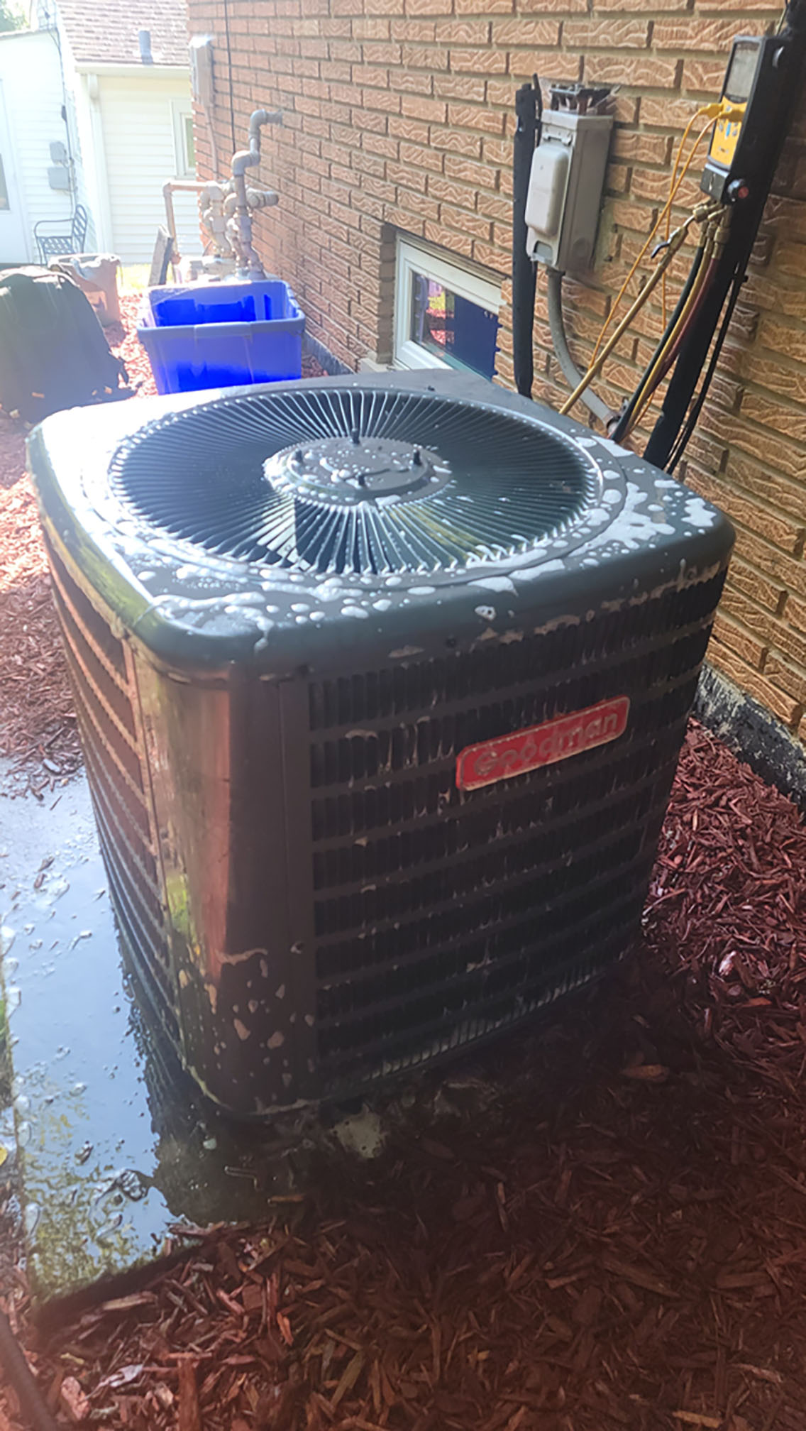 Foaming coil cleaner applied to an outdoor AC condenser during a seasonal tune-up