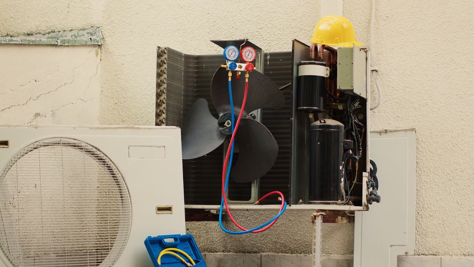 Ductless mini-split air conditioner connected to gauges for testing