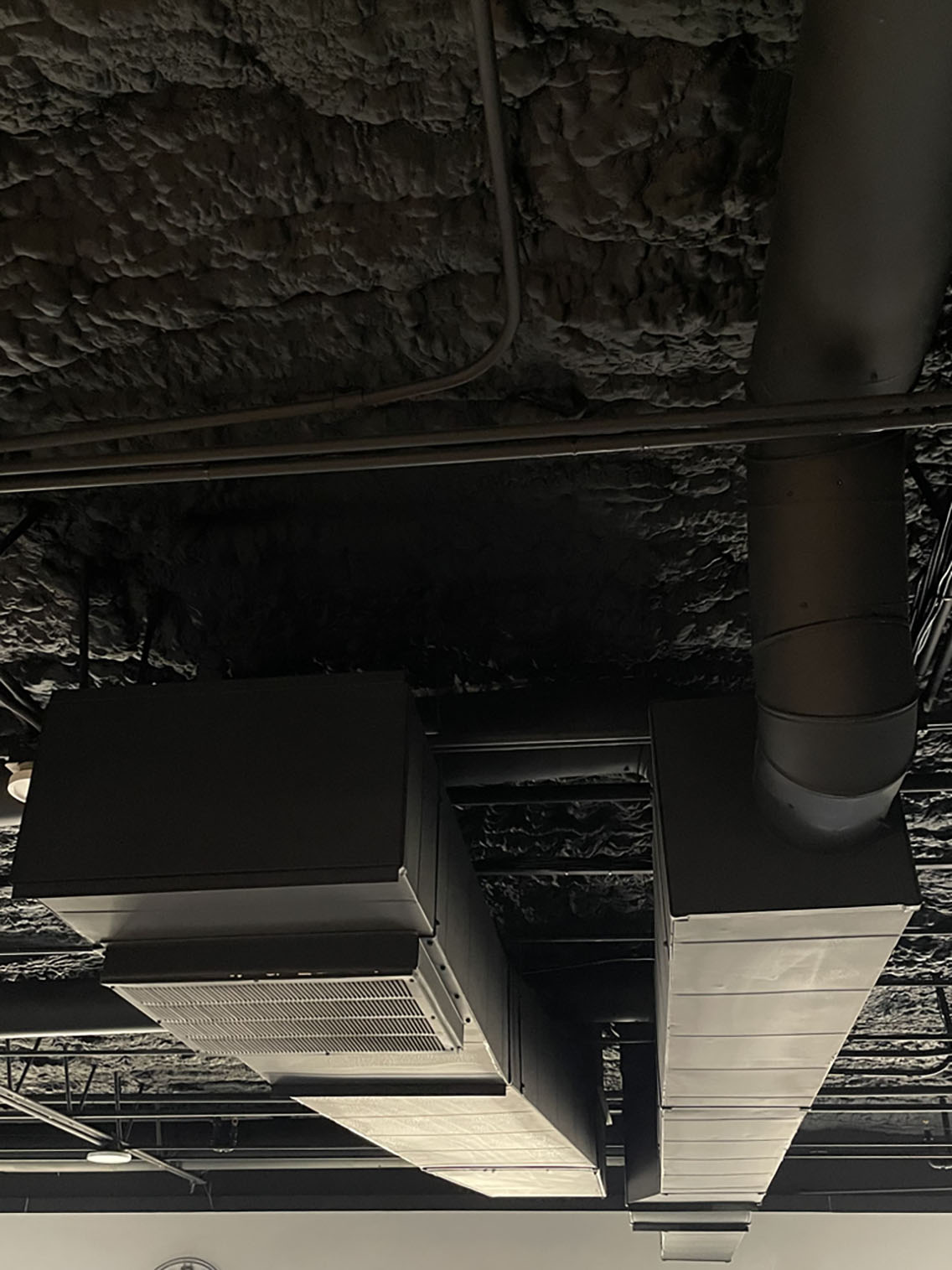 Reworked sheet metal ductwork and trunk lines installed overhead during a ductwork project in Elmhurst IL