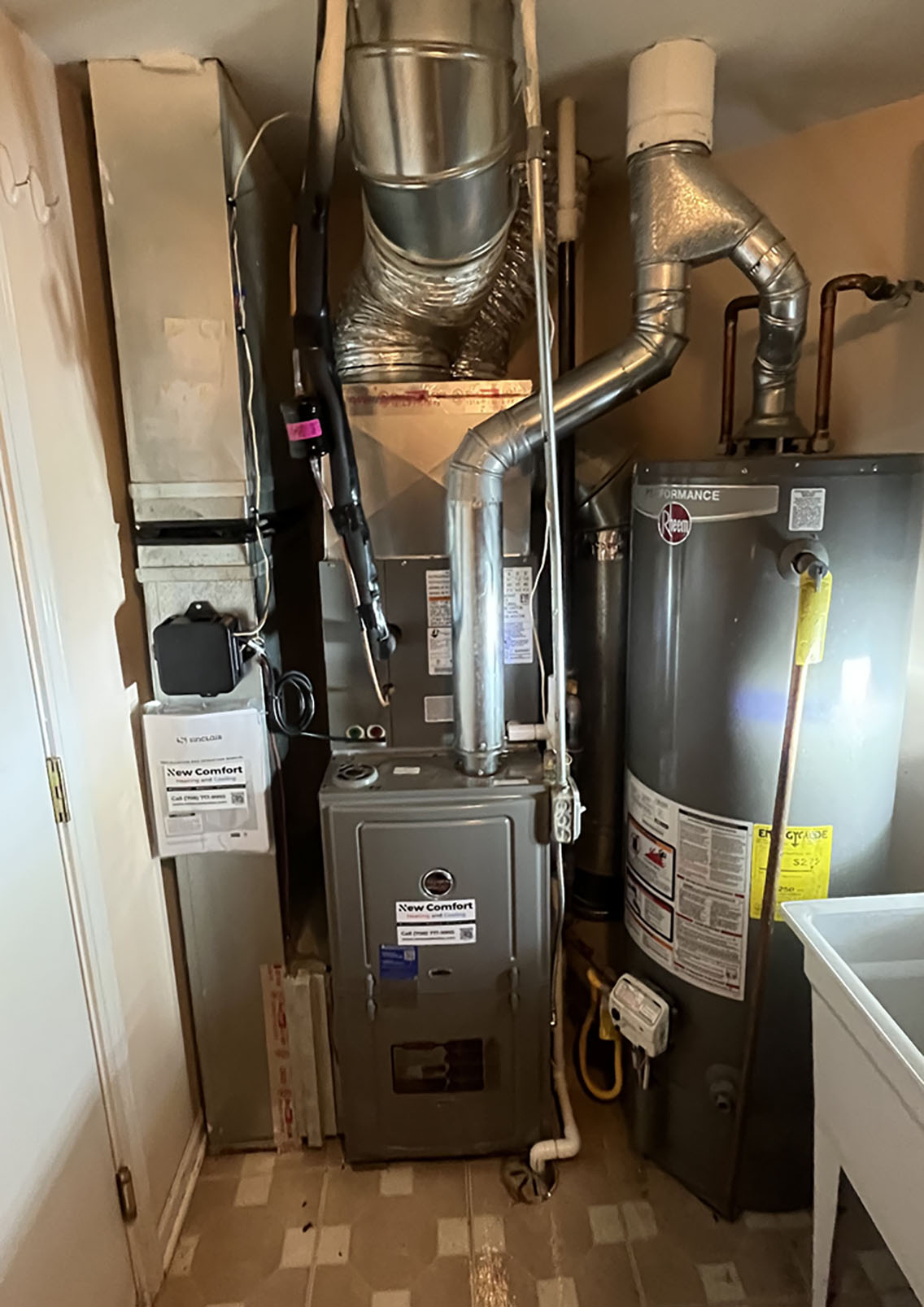 Clean furnace installation with new venting next to a gas water heater - HVAC services Homer Glen homeowners trust