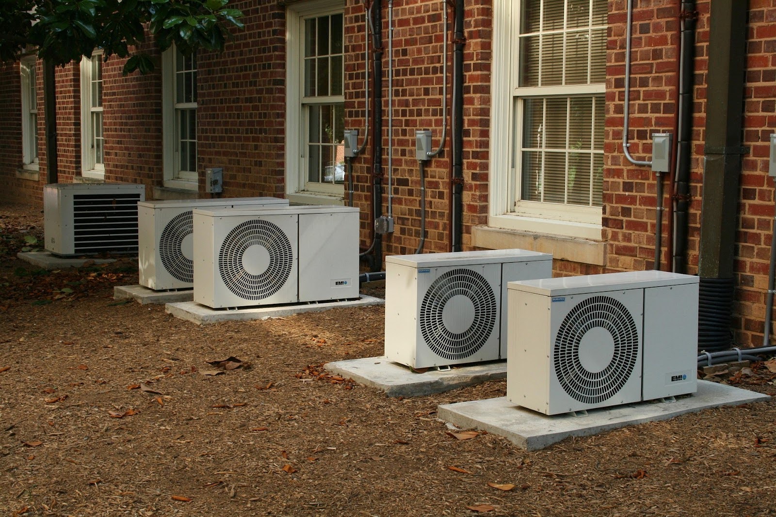 Row of outdoor condensing units maintained by a commercial HVAC repair service Row of outdoor condensing units maintained by a commercial HVAC repair service